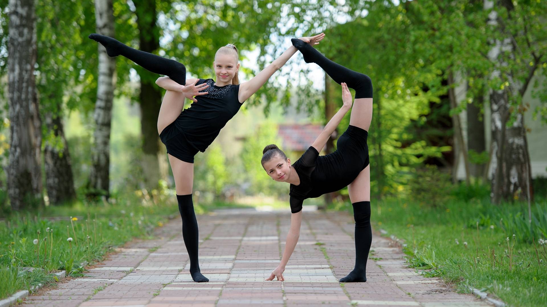Two young woman gymnast in black stand on split Stock Photo by ©Wisky  12861490
